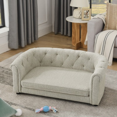 Light gray sofa in a living room setting with curtains and a side table.