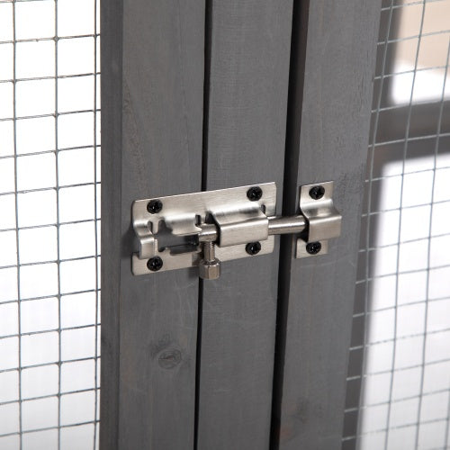 Metal door latch on a gray door with tiled walls in the background