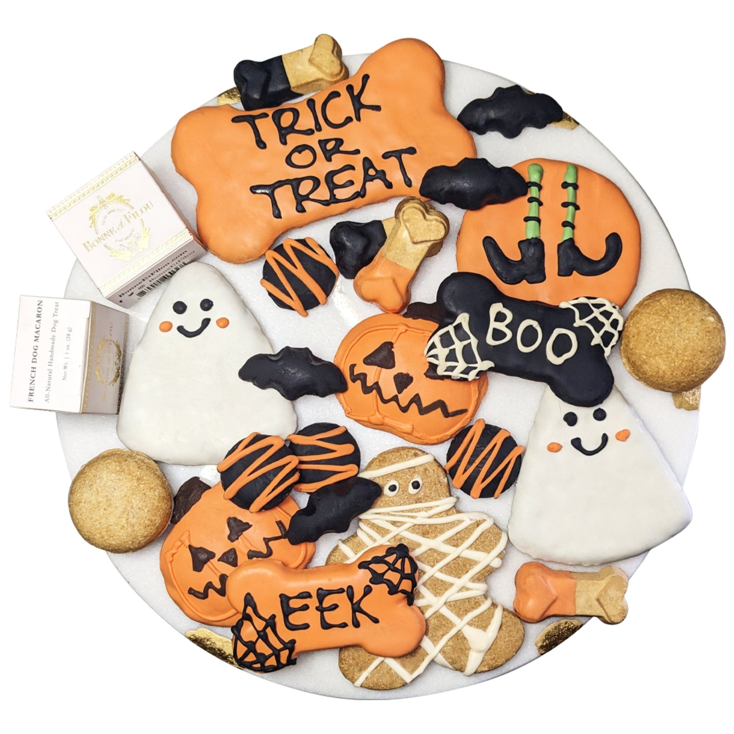 Halloween-themed cookies on a plate with 'Trick or Treat' and 'Boo' text.