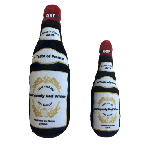 Two plush wine bottle toys with labels on a white background