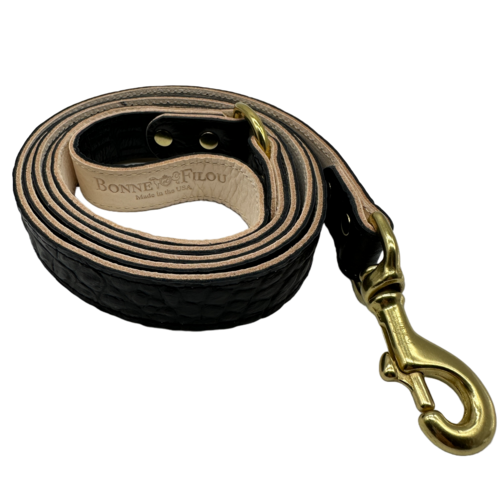 Black leather dog leash with gold clasp and 'Bonne Filou' branding on a white background