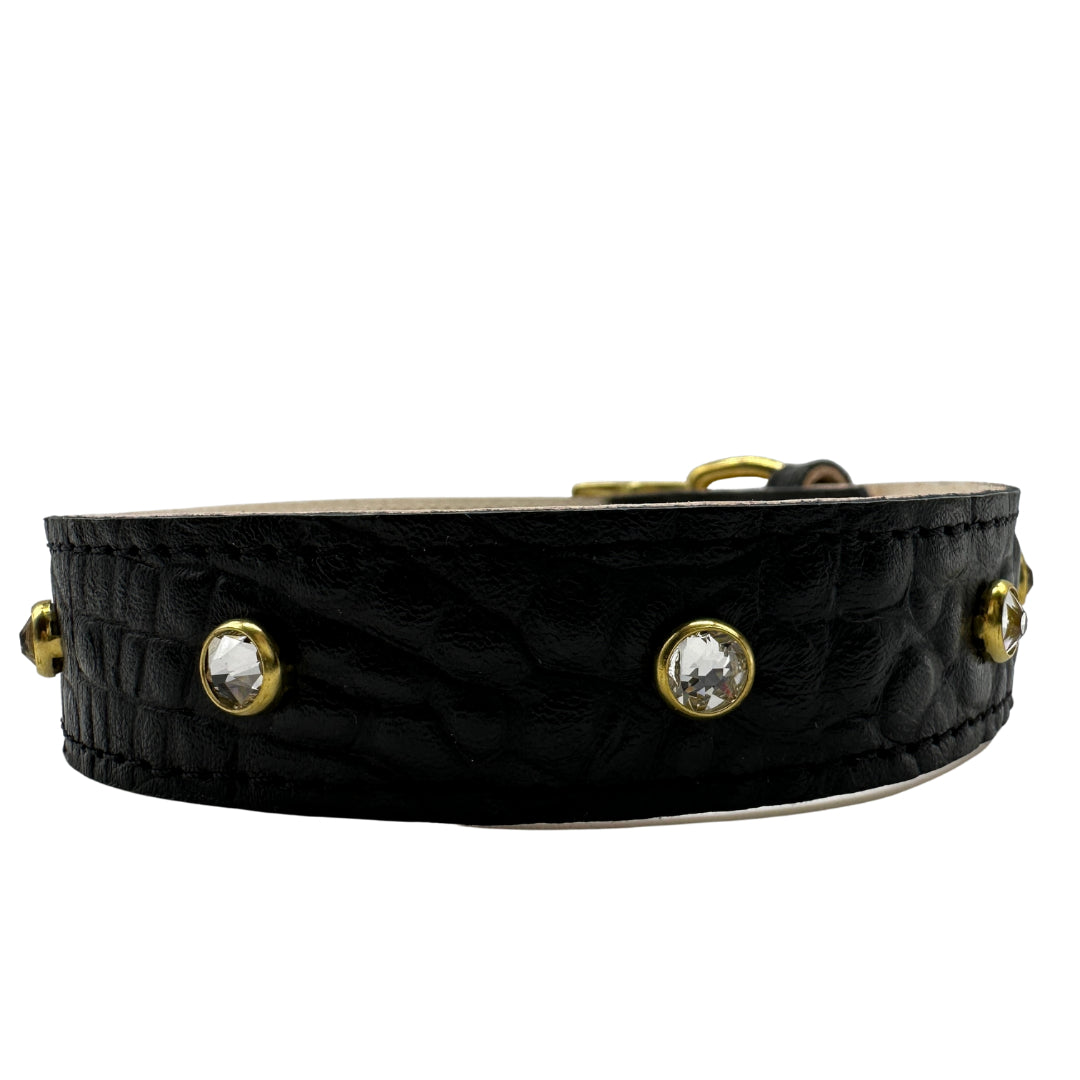 Black leather choker with gold accents and crystal-like stones on a white background