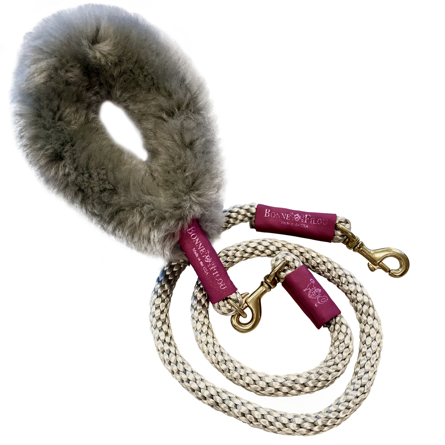 Dog leash with fur handle and branded clips on a white background