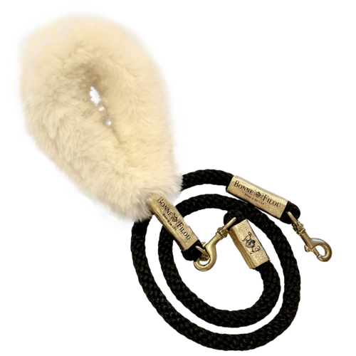 Dog leash with a fluffy beige handle on a white background