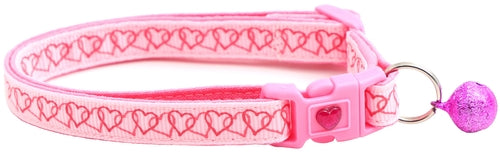 Pink cat collar with heart pattern and decorative ball on a white background