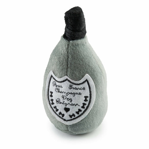 Plush toy shaped like a champagne bottle with a black top on a white background