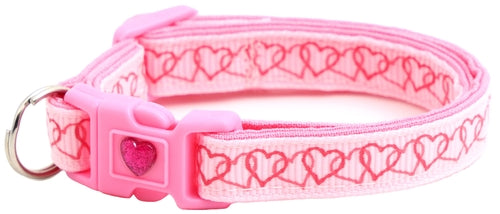 Pink dog collar with heart pattern on a white background