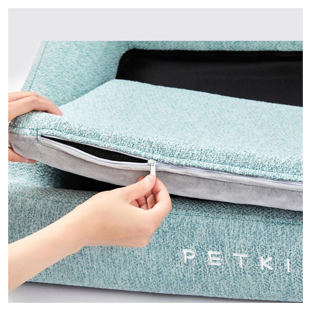 Light blue pet bed with a zipper being opened, featuring the brand 'PETKI'.