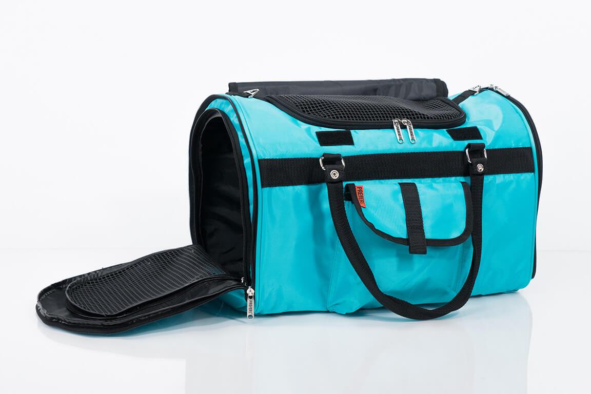 Turquoise pet carrier with black straps on a white background