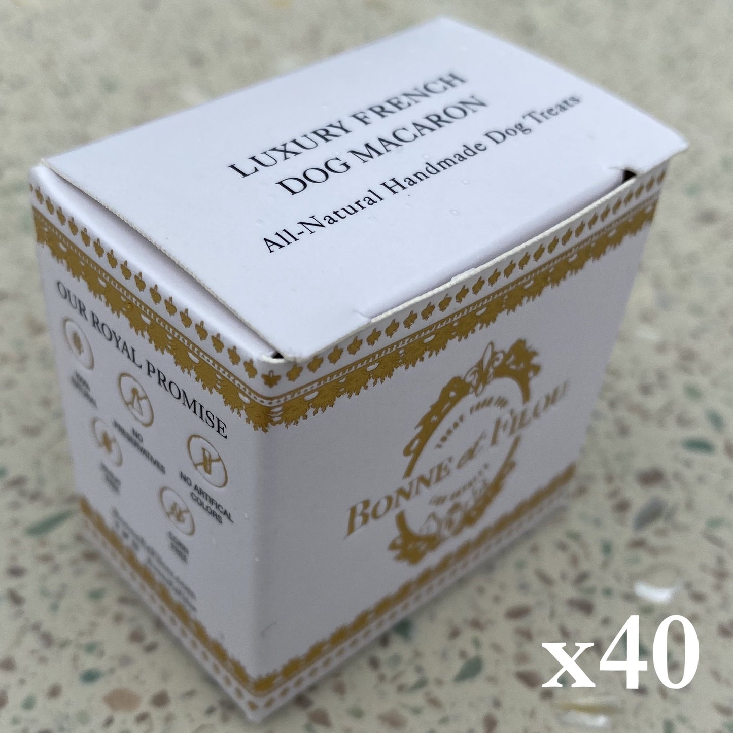 Box of Luxury French Dog Macaron dog treats on a textured surface