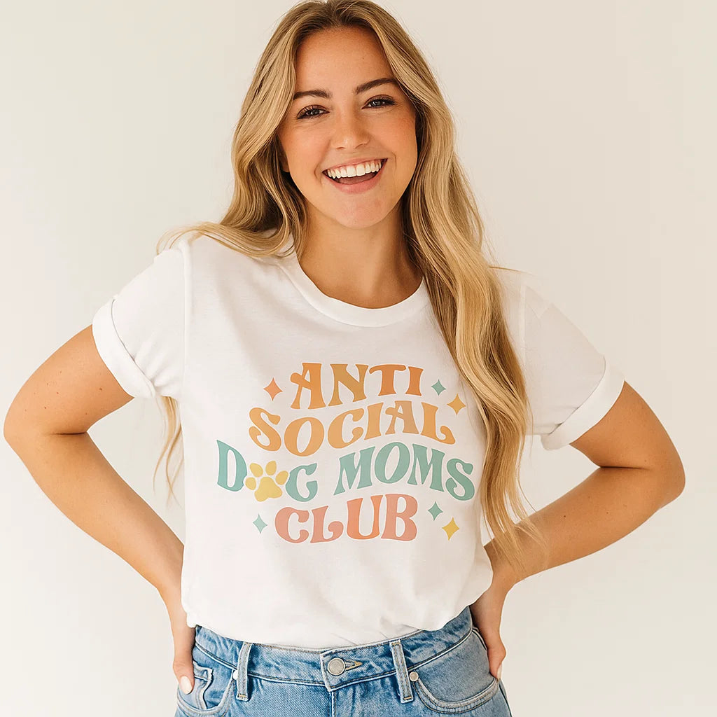 Woman wearing a white t-shirt with 'Anti Social Dog Moms Club' text on a plain background