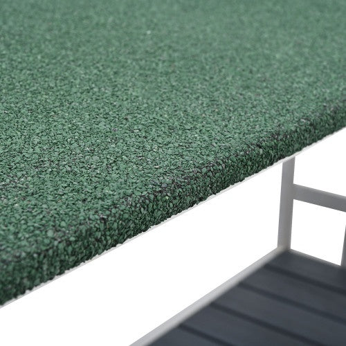 Close-up of green textured surface with a white base and metal structure.