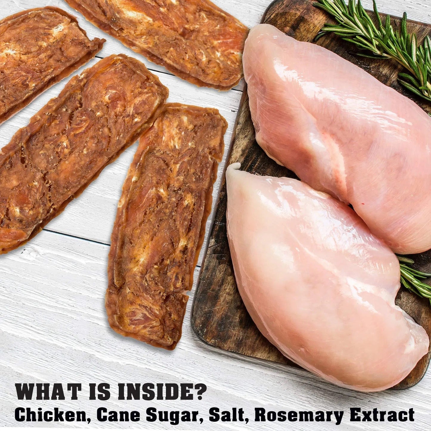 Raw chicken breasts and dried meat on a wooden board with rosemary, on a light wooden surface.