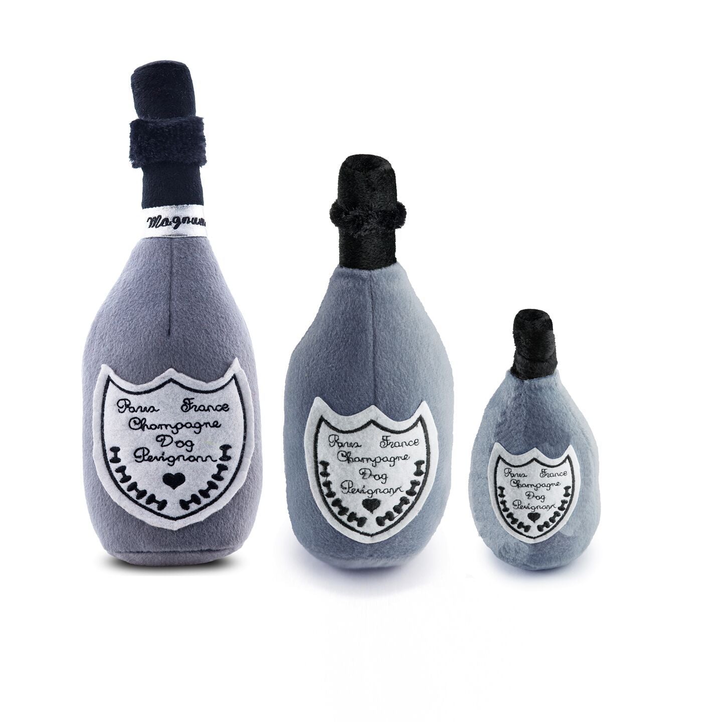 Three plush champagne bottle toys on a white background