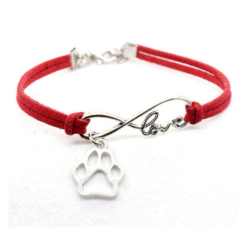 Red bracelet with silver infinity charm and paw print on a white background