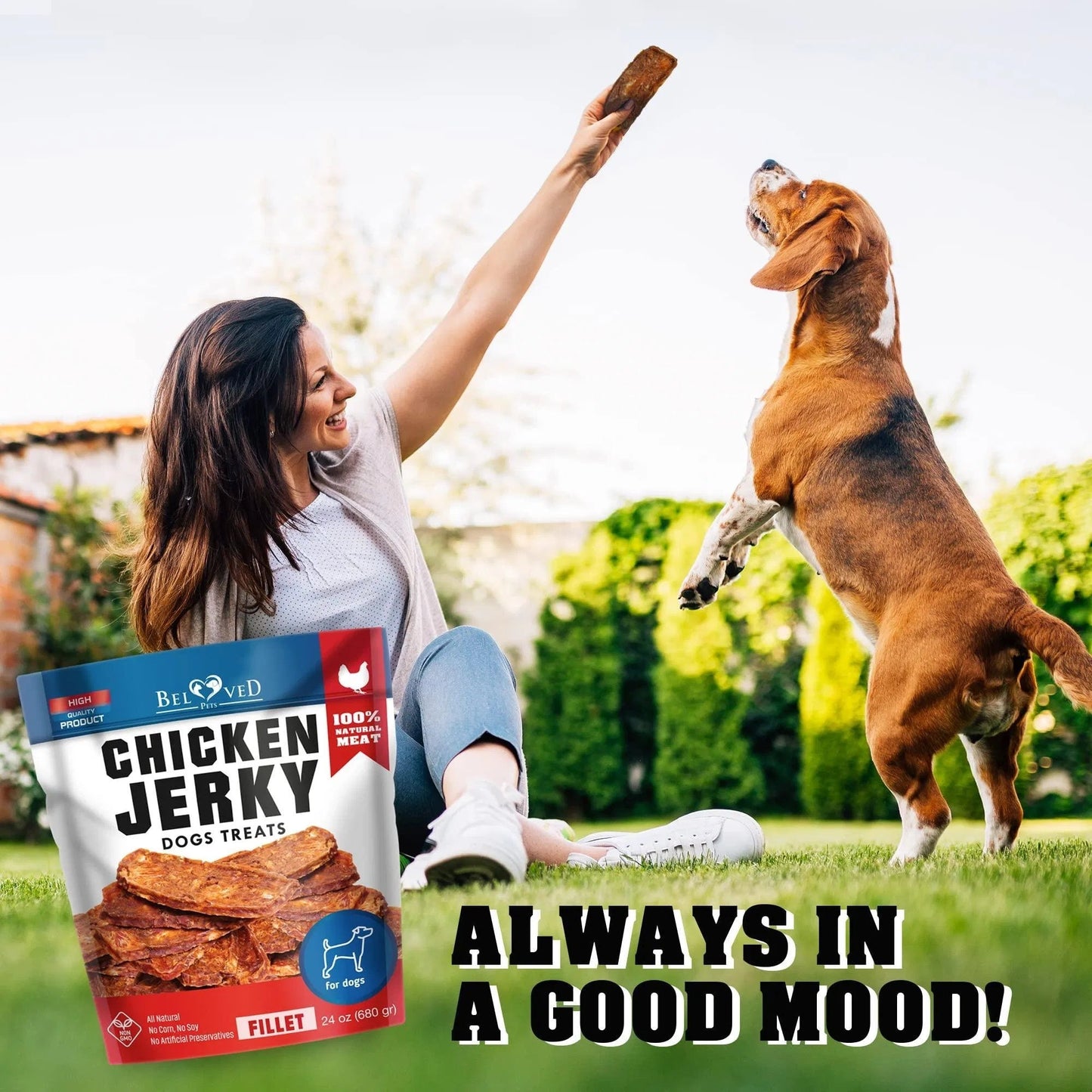 Woman and dog playing with a bag of Bixbi Chicken Jerky treats in a garden setting.