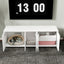 White pet furniture with cat beds and a TV displaying the time.