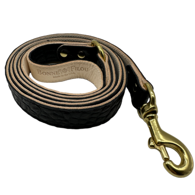 Black leather dog leash with gold clasp and 'Bonne Filou' branding on a white background