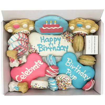 Box of birthday-themed cookies with decorative icing and text