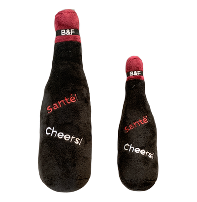 Two plush bottle-shaped toys with 'sante' and 'Cheers!' text on a white background.