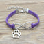Purple bracelet with silver paw charm and 'love' infinity symbol on a wooden surface
