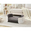 Gray pet bed in a living room setting with a couch and rug.