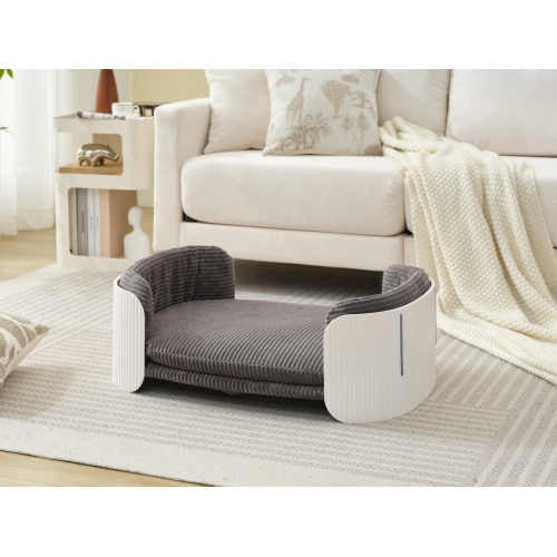 Gray pet bed in a living room setting with a couch and rug.