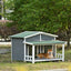 Doghouse with a dog sitting inside in a garden setting