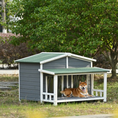 Doghouse with a dog sitting inside in a garden setting