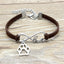 Bracelet with paw charm and 'love' infinity symbol on brown cord, on wooden surface