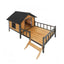 Wooden pet house with a black roof and stairs on a white background