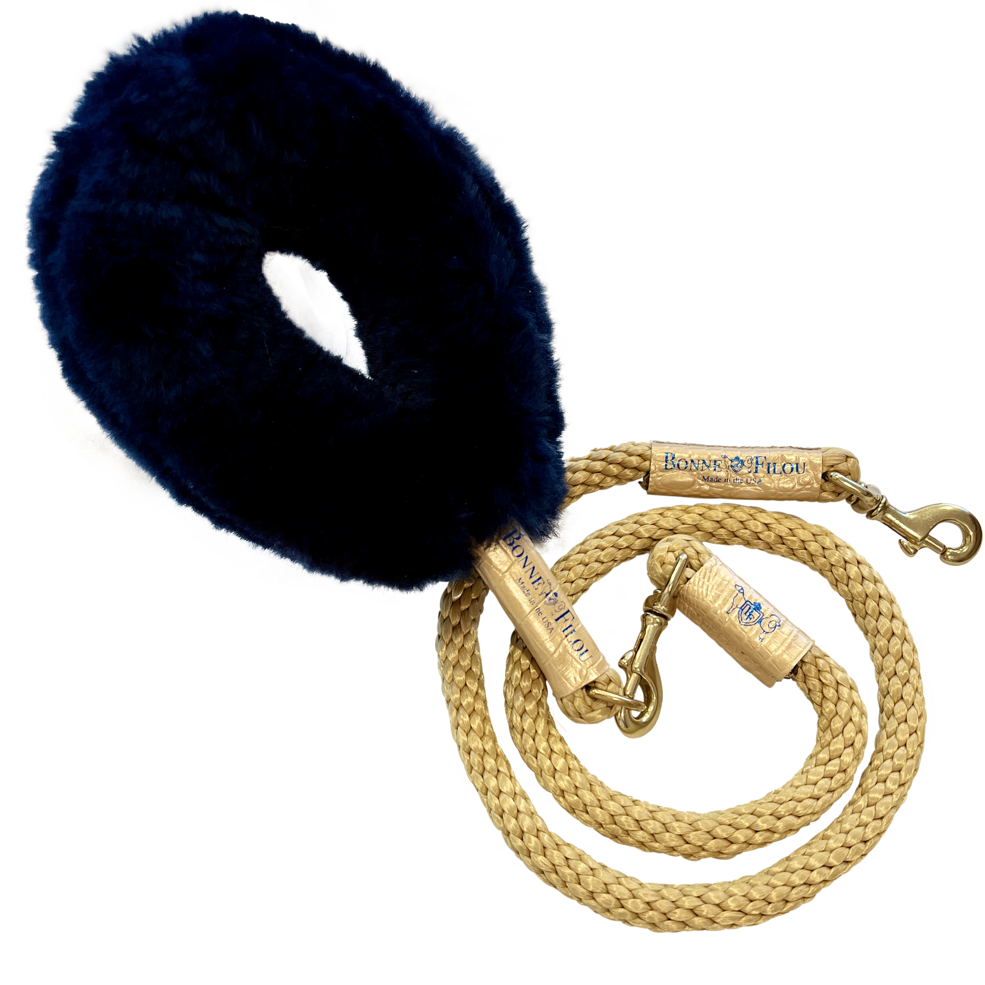 Navy blue leather dog muzzle with a braided gold leash on a white background