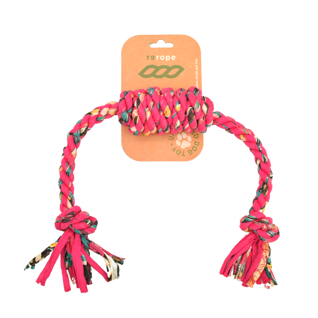 Pink dog rope toy with colorful patterns on a white background