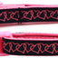 Pink and black dog collar with heart pattern on a white background