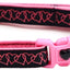 Pink and black dog collar with heart design and keychain on a white background