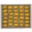 Box of pumpkin spice macarons with cream filling on a white background