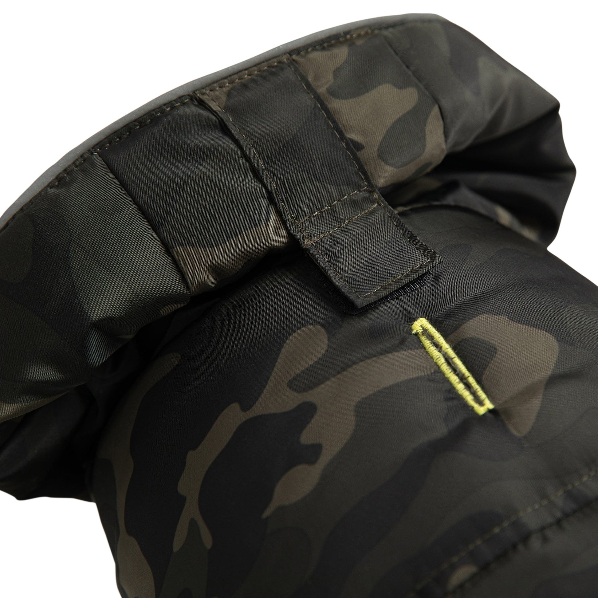 Camouflage-patterned jacket with a yellow zipper on a white background