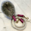 Dog collar with fluffy texture and braided leash on a white background