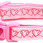 Pink dog collar with heart pattern on a white background