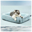 Cat lying on a light blue pet bed with a soft cloud background