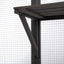 Wooden pergola structure with metal support beams against a wire fence background