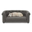 Dog lying on a gray pet sofa against a white background