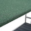 Close-up of green textured surface with a white base and metal structure.
