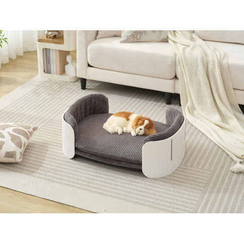 Pet bed with plush toys on a rug in a living room setting