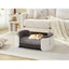 Gray pet bed with a dog inside in a living room setting