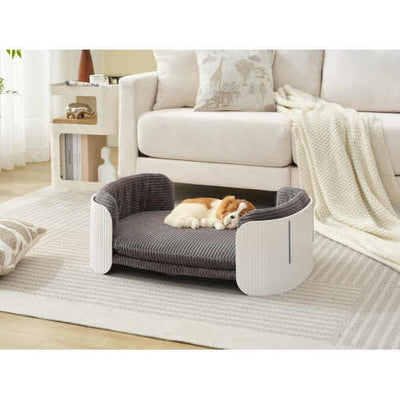 Gray pet bed with a dog inside in a living room setting