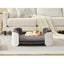 Dog lying on a elevated pet bed in a living room setting