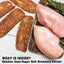 Raw chicken breasts and dried meat on a wooden board with rosemary, on a light wooden surface.