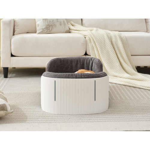 Round pet bed with a gray cushion on a light-colored rug in a living room setting.