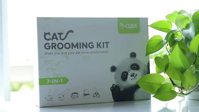 Cat grooming kit box with panda illustration on a white surface with green leaves in the background